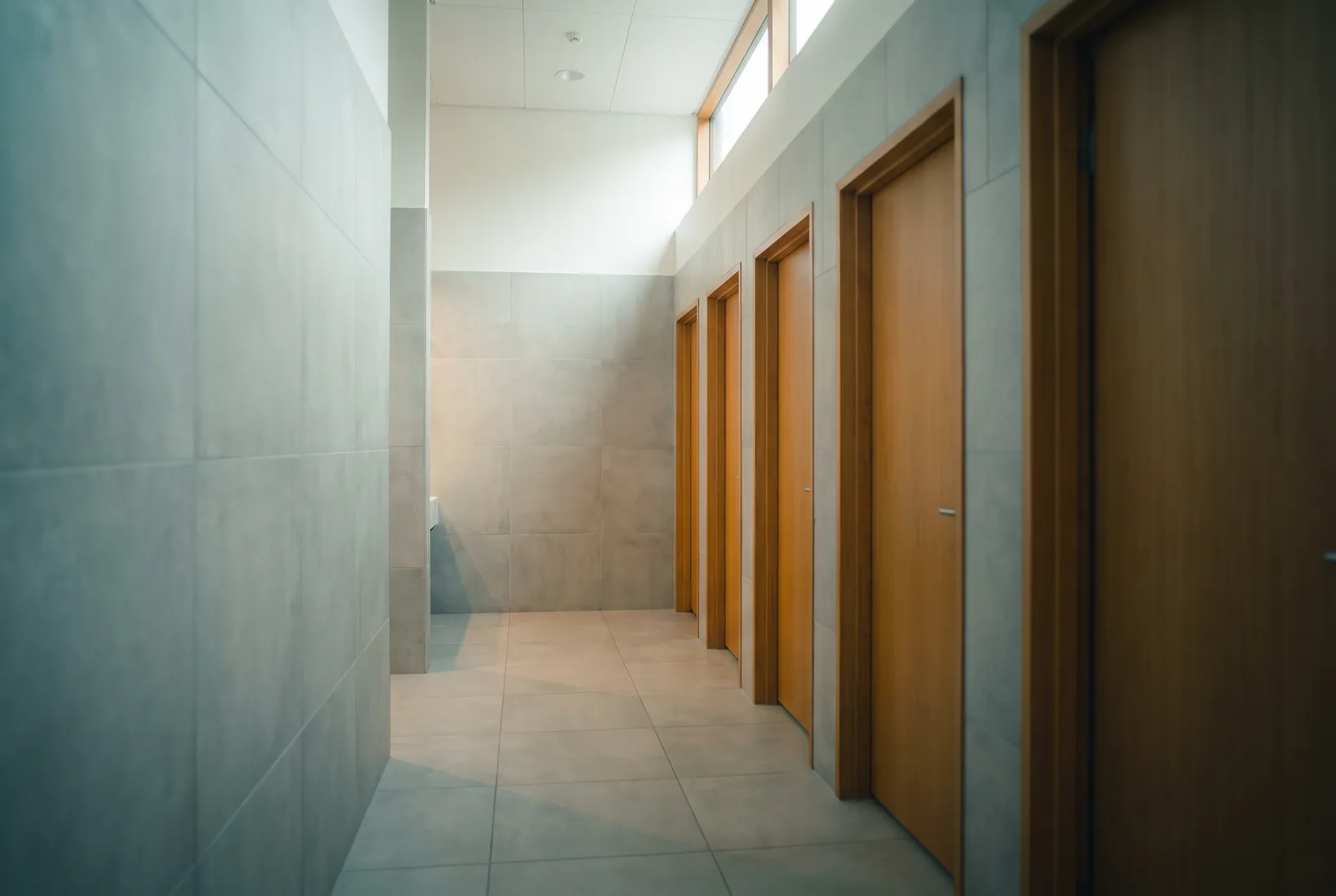 A clean, empty public restroom corridor